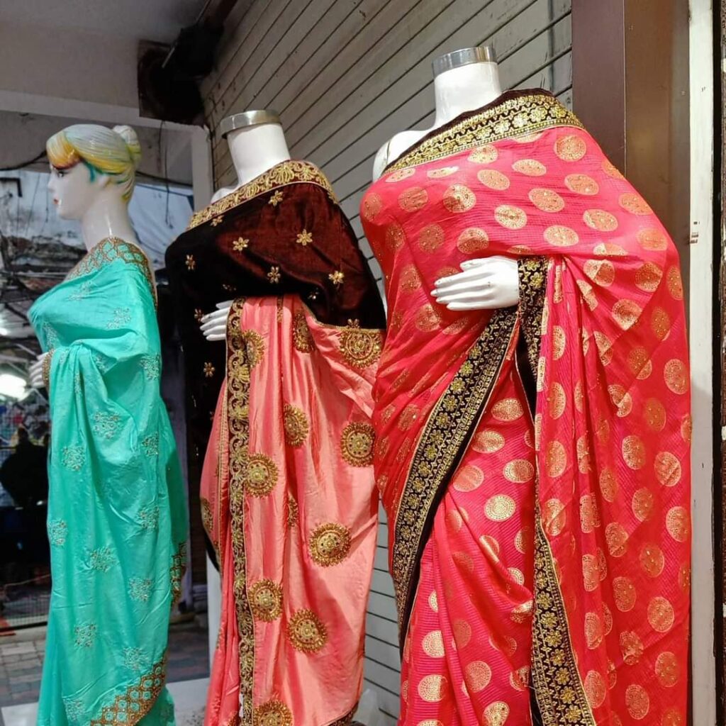 Women wearing traditional Indian saris in different regional drapes