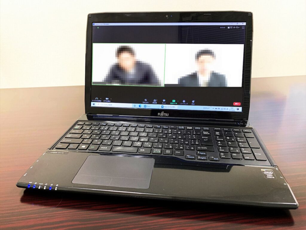 A person on a video call on a laptop, as in an online mentoring session